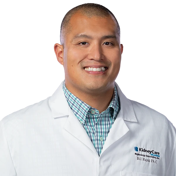 portrait of Bill Huynh wearing a blue and green striped shirt and white jacket.