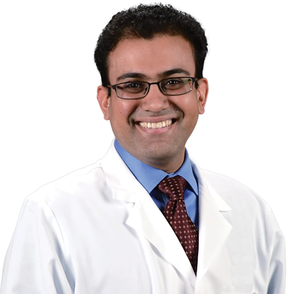 profile picture of Dr. Ahmad wearing a blue shirt, burgundy tie and white lab coat.